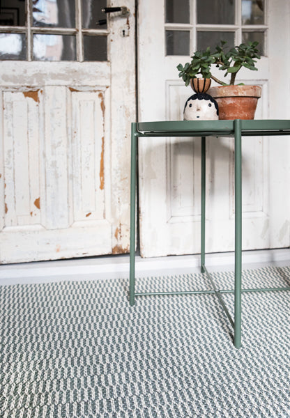 Pemba Woven Plastic Rug by Brita, showing closeup view of pemba woven plastic rug in live shot.