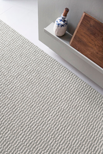 Pemba Woven Plastic Rug by Brita, showing closeup view of pemba woven plastic rug in live shot.