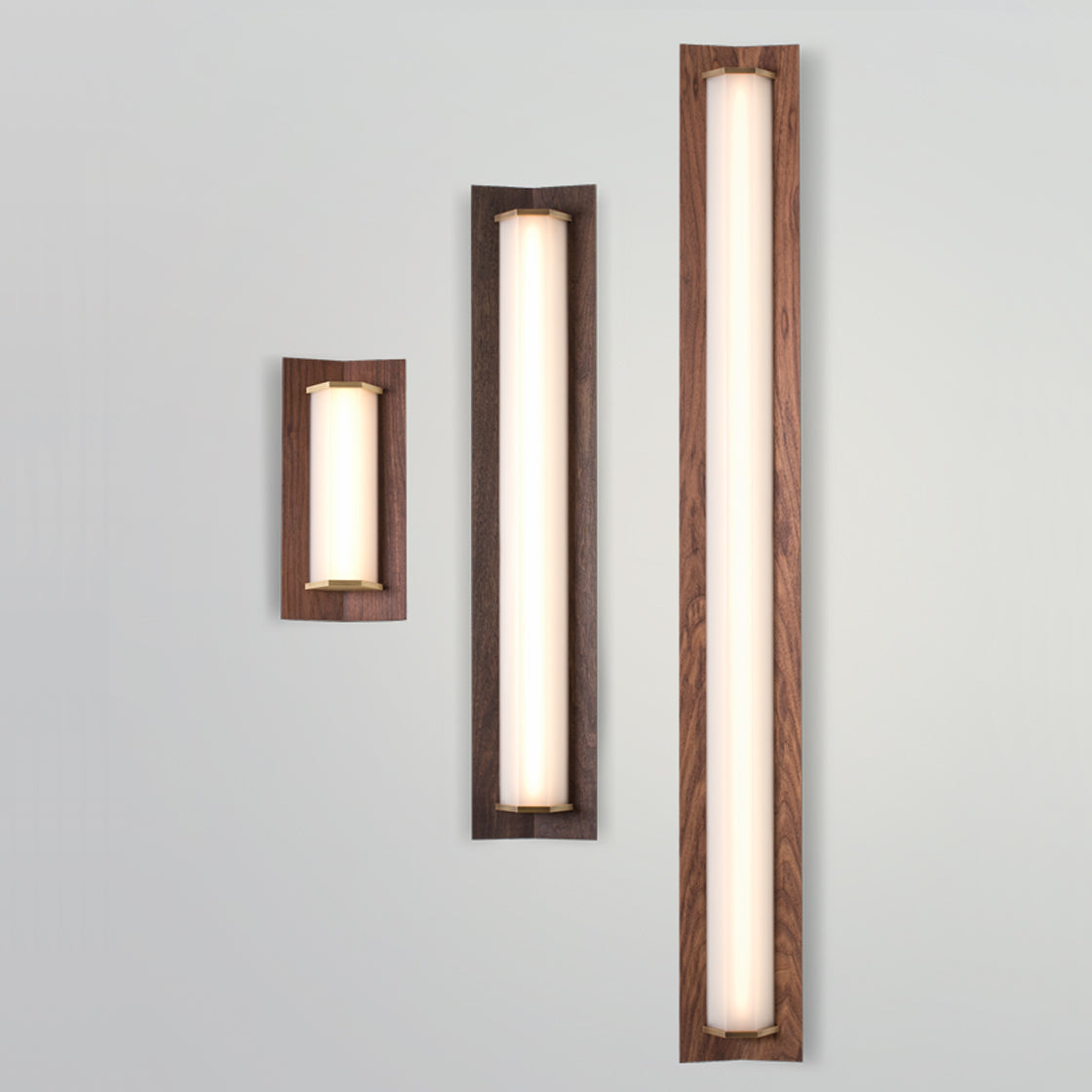Penna LED Sconce by Cerno, showing front view of penna led sconce in 16"& 64", brushed brass metal + walnut wood & 40", brushed brass metal + dark stained walnut wood.
