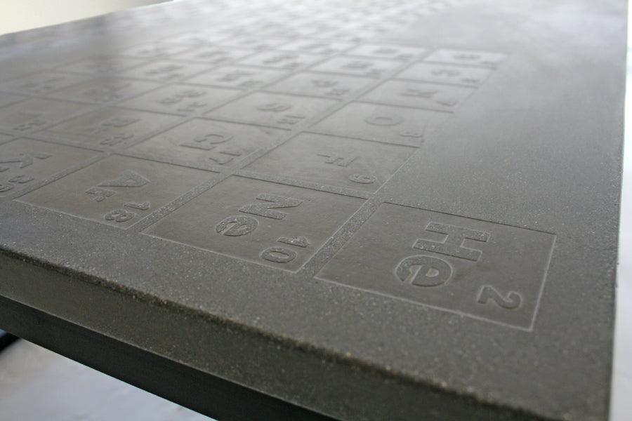 James De Wulf Periodic Coffee Table by De Wulf, showing closeup view of periodic coffee table in natural tone concrete.