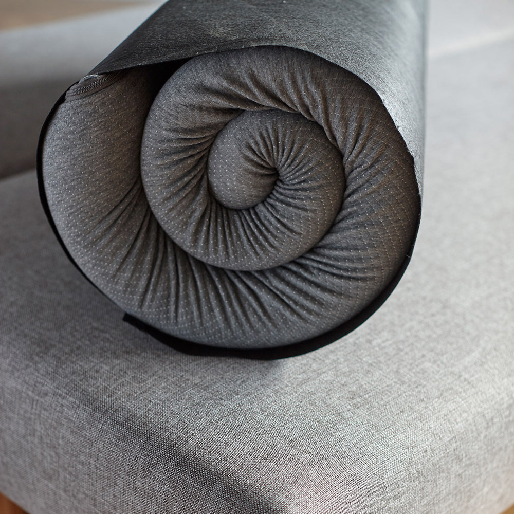 Pillow Topper by Innovation, showing closeup of pillow topper with storage bag in live shot.