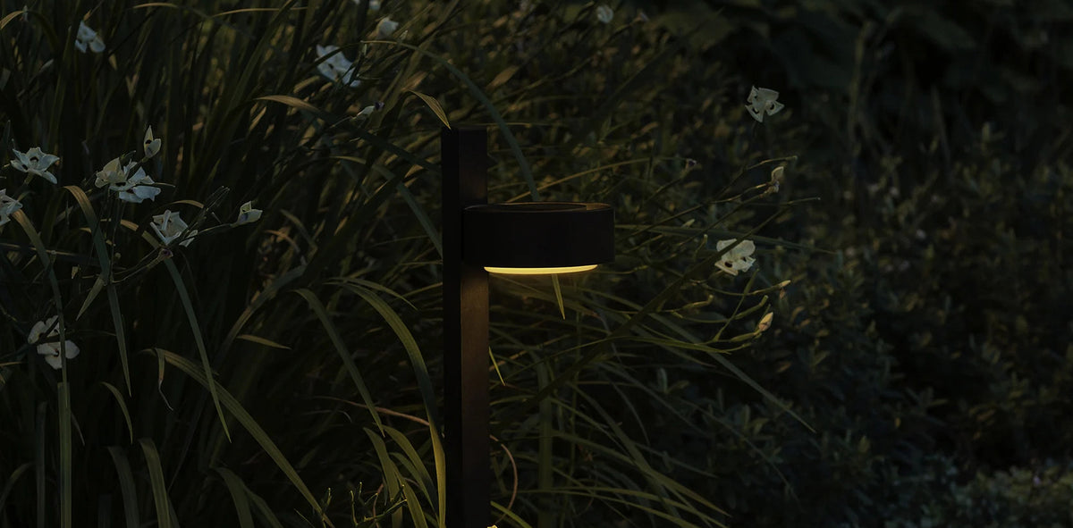 Plaff-On B IP65 Bollard Outdoor Light by Marset, showing closeup view of plaff-on b ip65 bollard outdoor light in live shot.