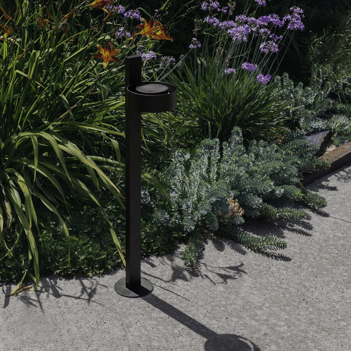 Plaff-On B IP65 Bollard Outdoor Light by Marset, showing plaff-on b ip65 bollard outdoor light in live shot.