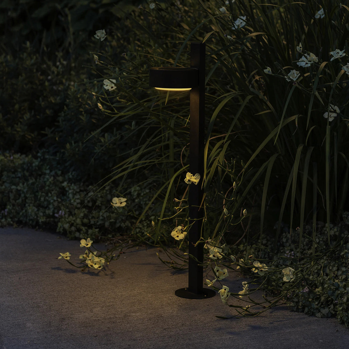 Plaff-On B IP65 Bollard Outdoor Light by Marset, showing plaff-on b ip65 bollard outdoor light in live shot.