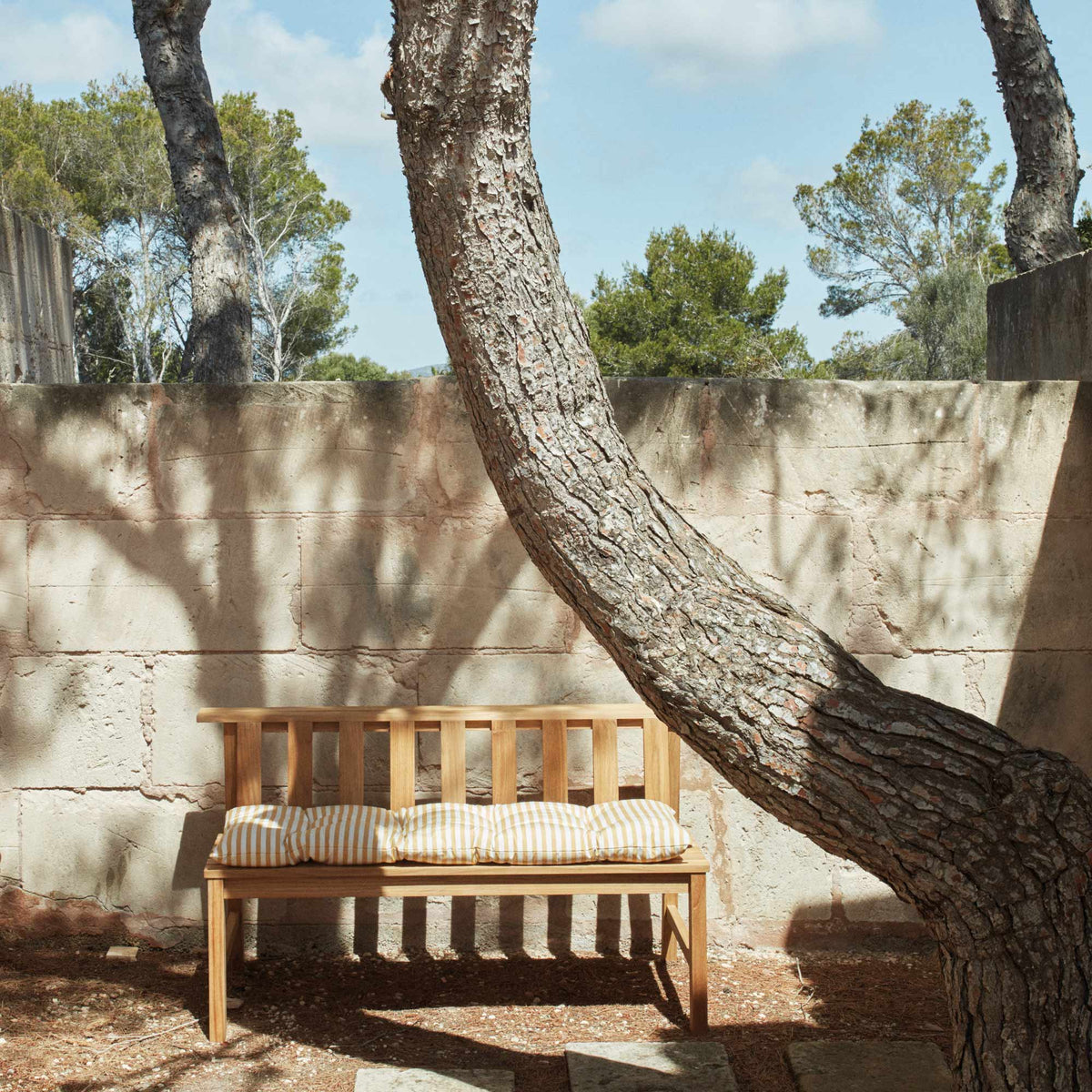 Plank Bench 144 by Skagerak, showing plank bench 144 with cushion in live shot.
