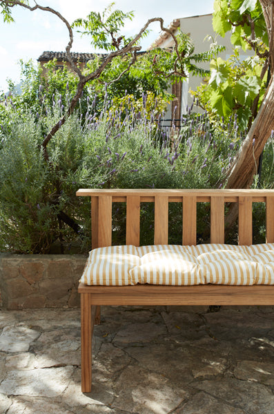 Plank Bench 144 by Skagerak, showing side view of plank bench 144 with cushion in live shot.