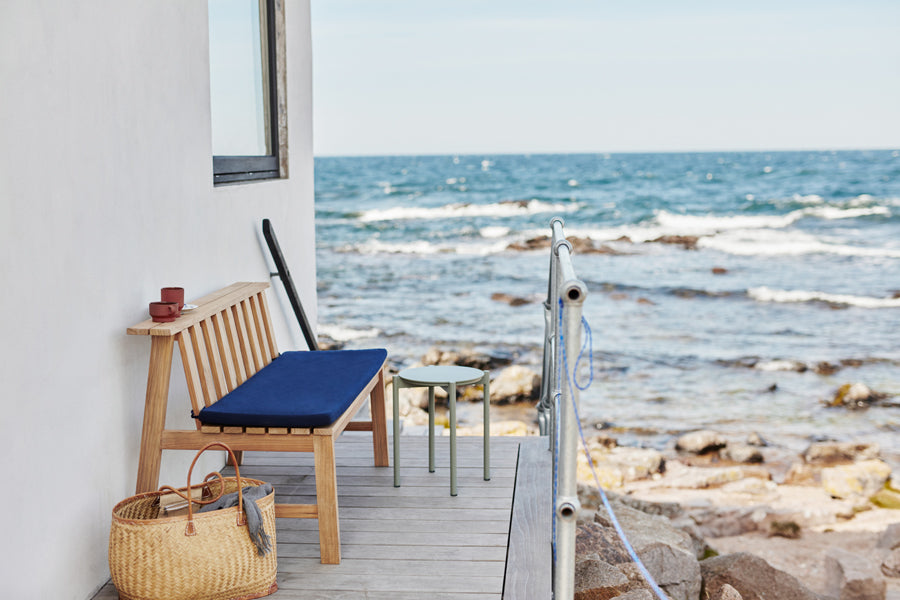Plank Bench 144 by Skagerak, showing plank bench 144 with cushion in live shot.