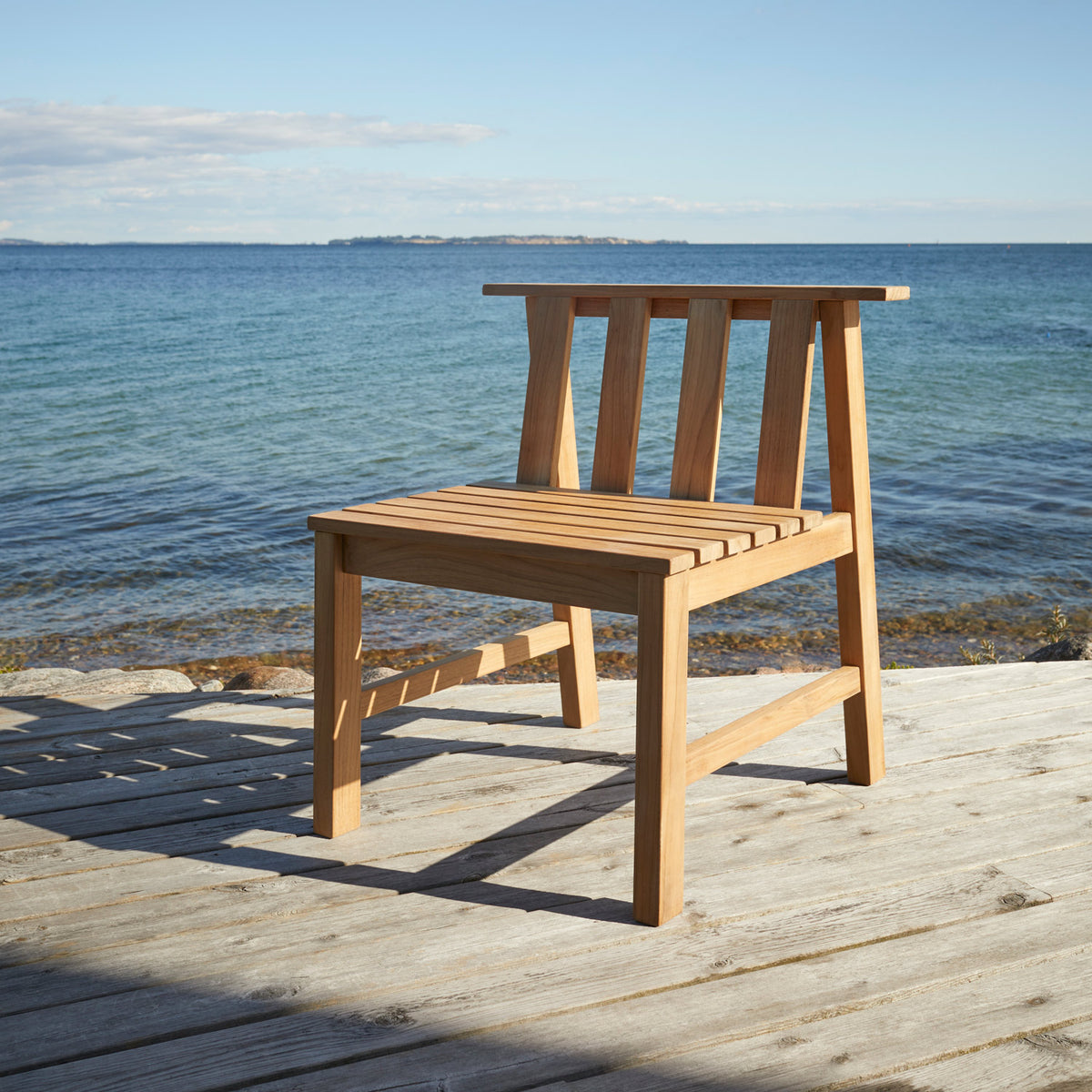Plank Outdoor Chair by Skagerak, showing plank outdoor chair in live shot.