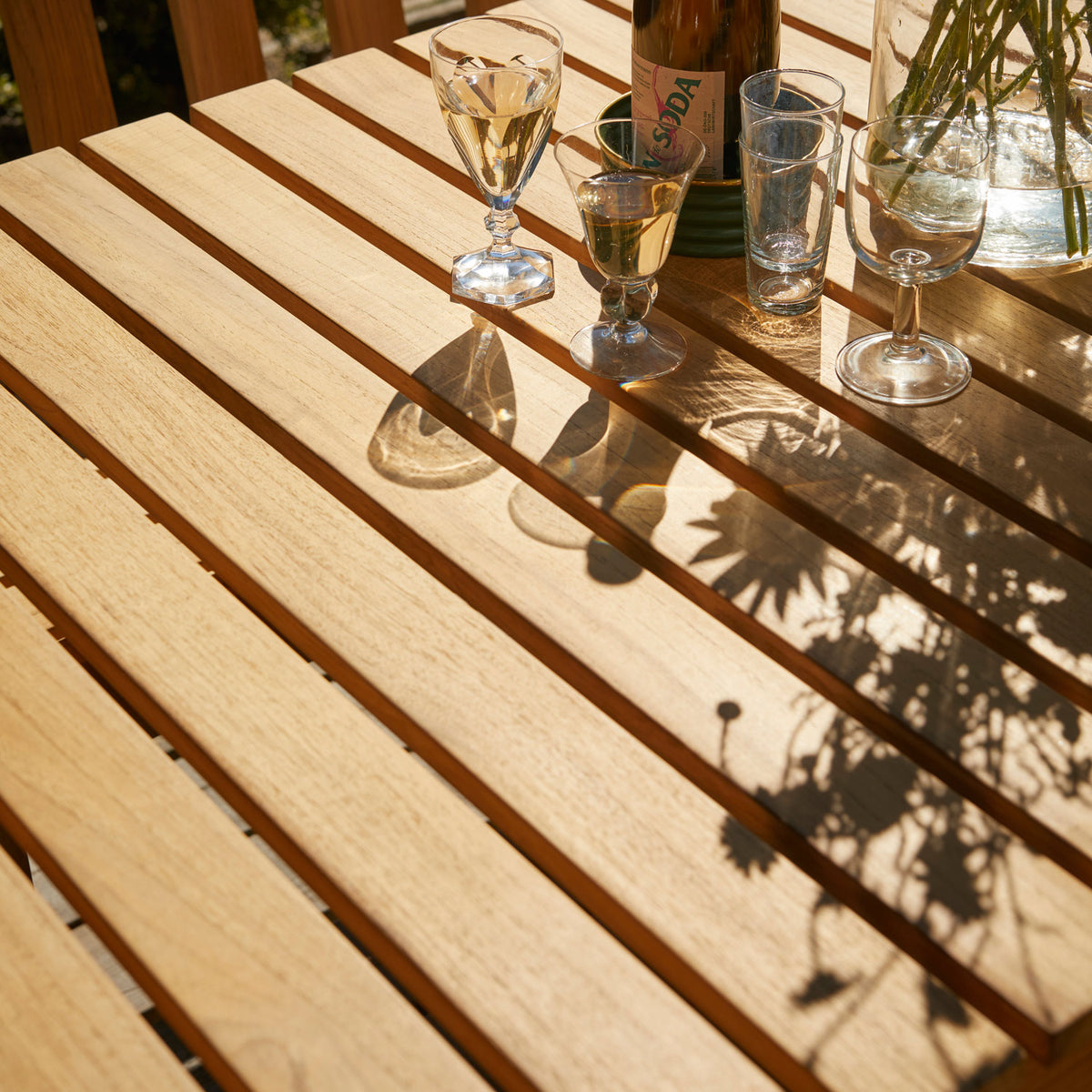 Plank Outdoor Table by Skagerak, showing closeup view of plank outdoor table in live shot.