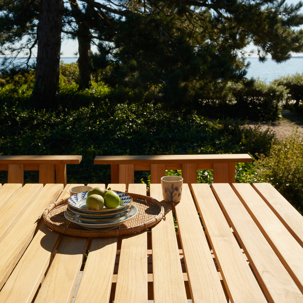 Plank Outdoor Table by Skagerak, showing closeup view of plank outdoor table in live shot.