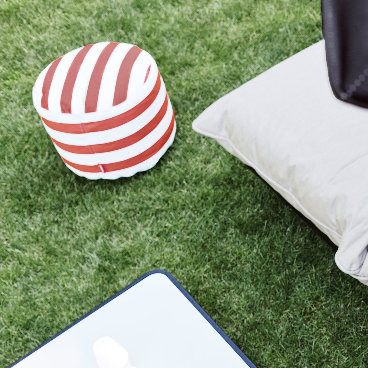 Point Outdoor Pouf/Ottoman by Fatboy, showing point outdoor pouf/ottoman in live shot.