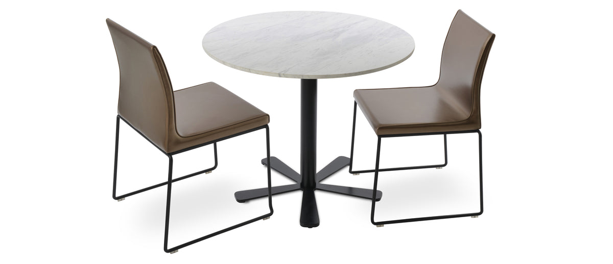 Polo Wire Stackable Chair by SohoConcept, showing two polo wire stackable chairs in gold ppm (flexible back)/black base with daisy dining table/marble top with black base.