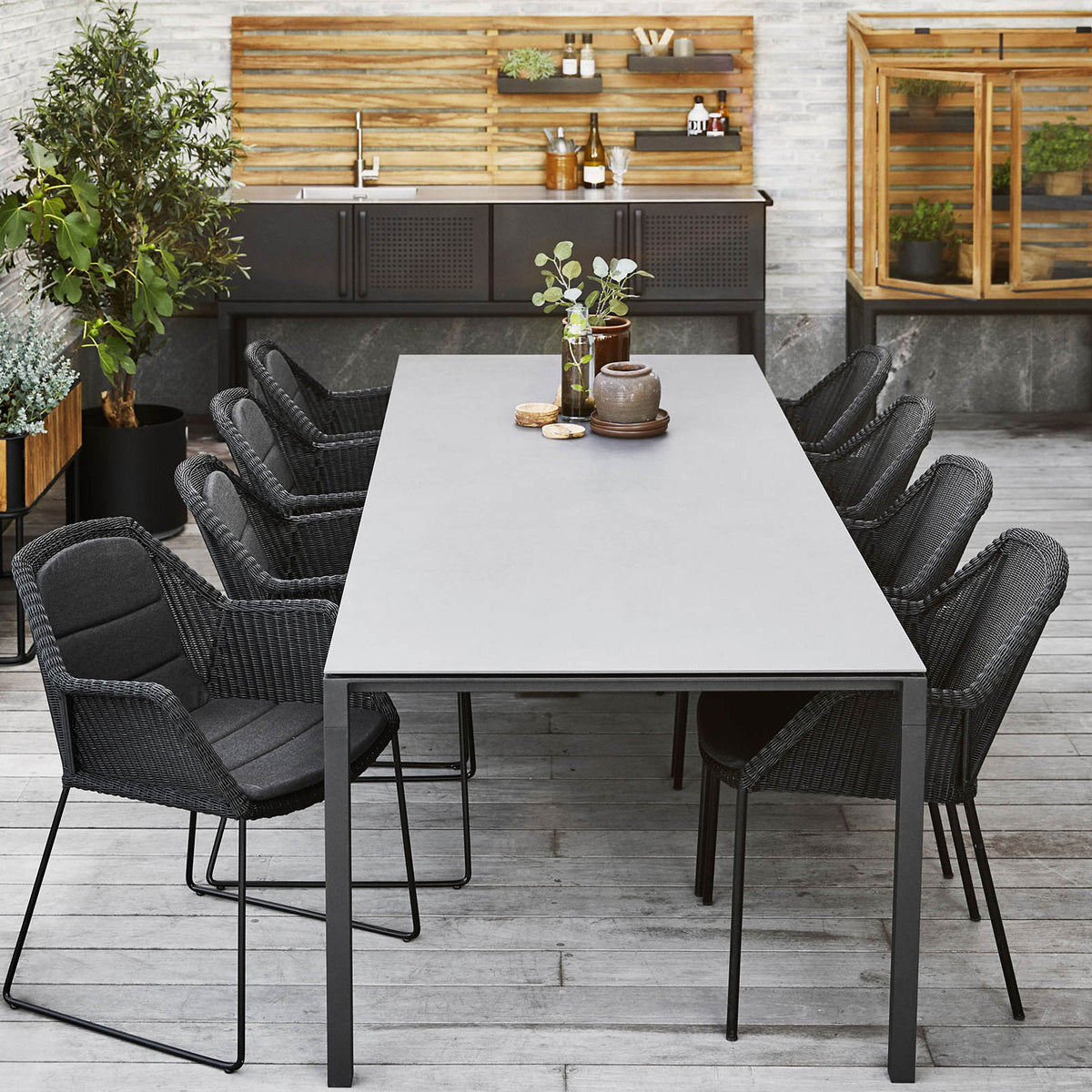 Pure 110.3" Aluminum Rectangular Dining Table by Cane-Line, showing pure 110.3" aluminum rectangular dining table with dining chairs in live shot.