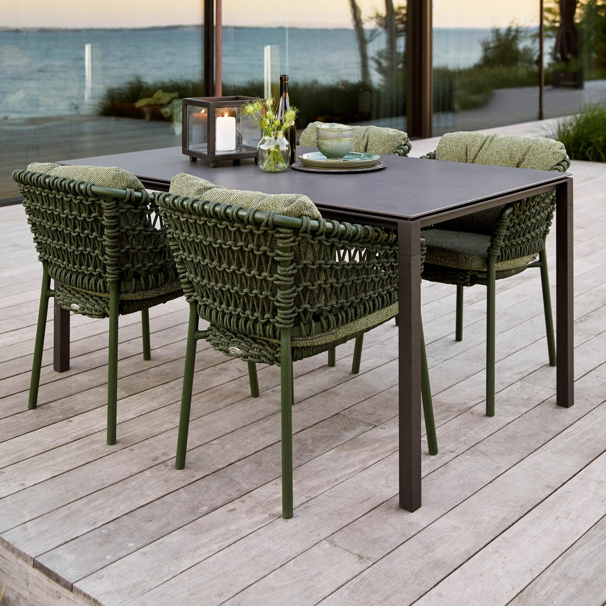 Pure 59.1" Aluminum Rectangular Dining Table by Cane-Line, showing pure 59.1" aluminum rectangular dining table with dining chairs in live shot.