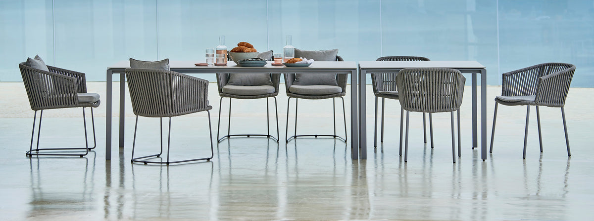 Pure 78.8" Aluminum Rectangular Dining Table by Cane-Line, showing pure 78.8" aluminum rectangular dining table with dining chairs in live shot.