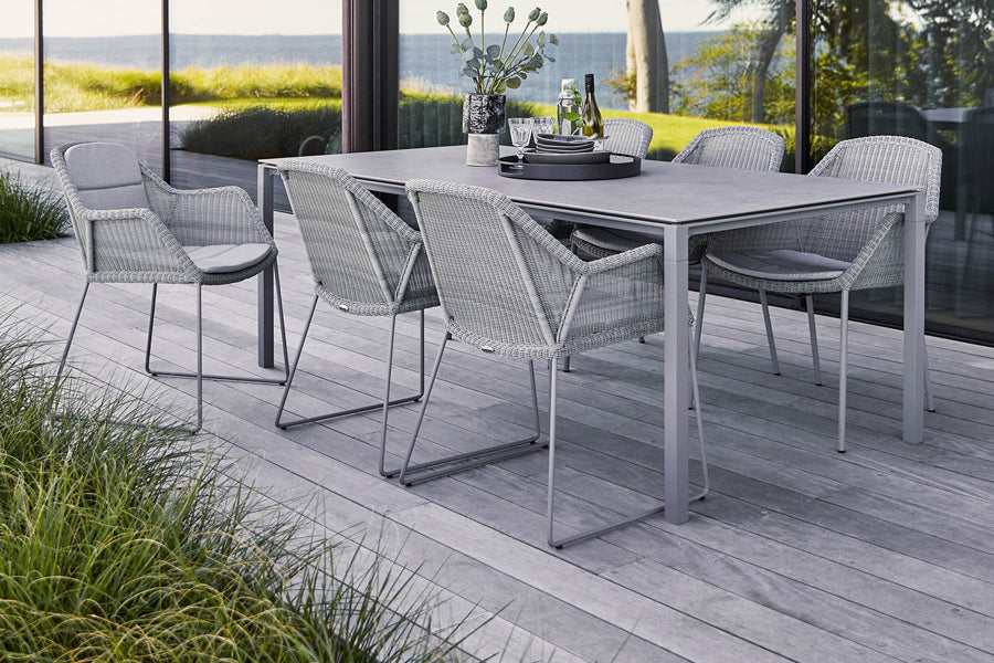 Pure 78.8" Aluminum Rectangular Dining Table by Cane-Line, showing pure 78.8" aluminum rectangular dining table with dining chairs in live shot.