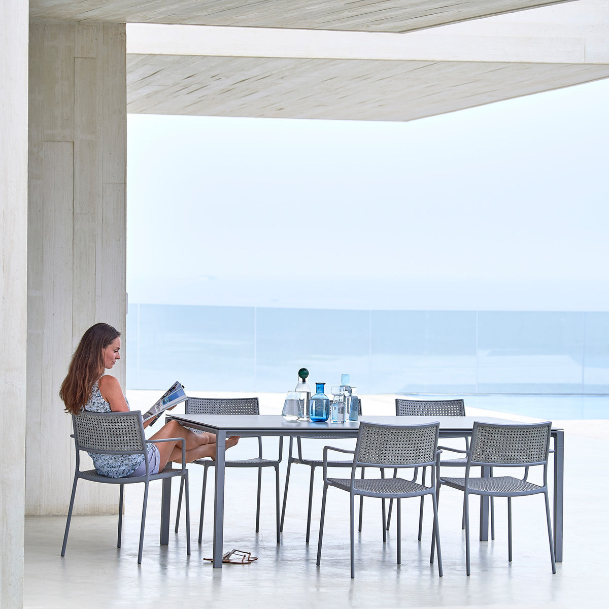Pure 78.8" Aluminum Rectangular Dining Table by Cane-Line, showing pure 78.8" aluminum rectangular dining table with dining chairs in live shot.