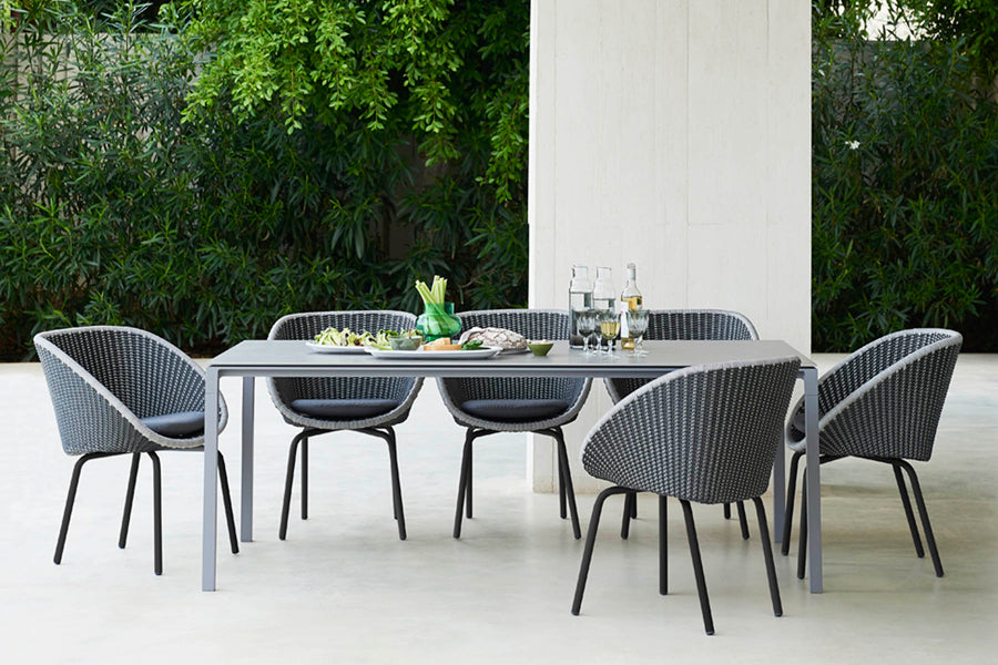 Pure 78.8" Aluminum Rectangular Dining Table by Cane-Line, showing pure 78.8" aluminum rectangular dining table with dining chairs in live shot.