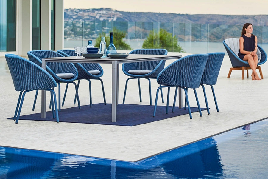 Pure 78.8" Aluminum Rectangular Dining Table by Cane-Line, showing pure 78.8" aluminum rectangular dining table with dining chairs in live shot.