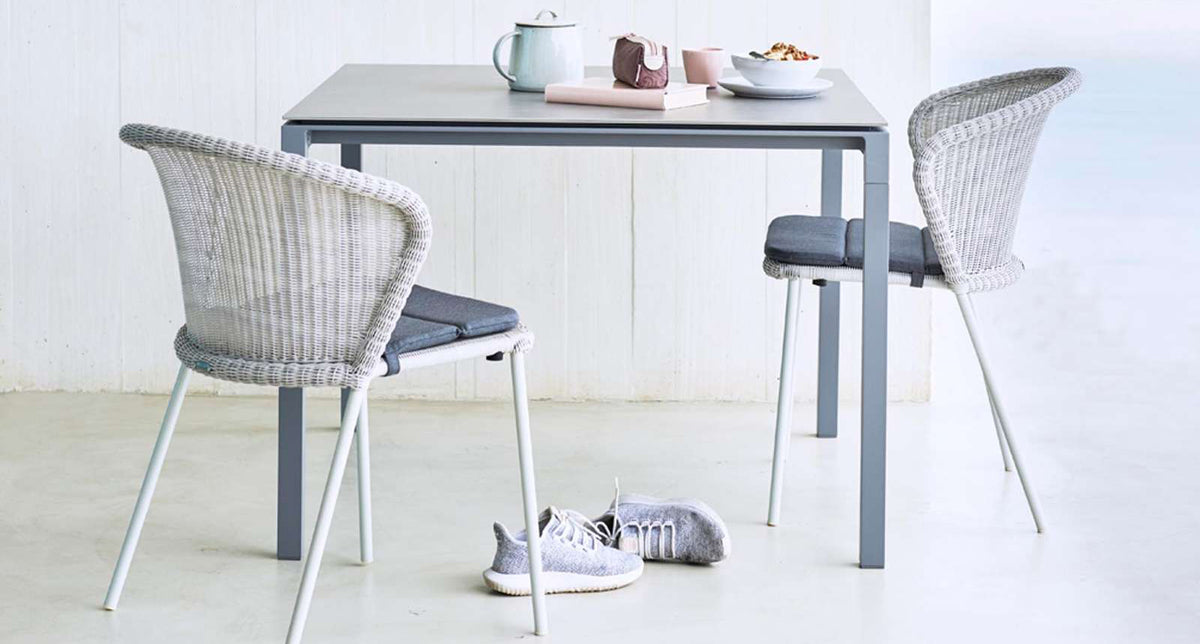 Pure Aluminum Square Dining Table by Cane-Line, showing pure aluminum square dining table with chairs in live shot.