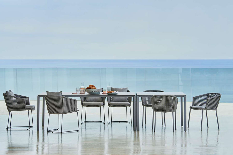 Pure Aluminum Square Dining Table by Cane-Line, showing pure aluminum square dining table with chairs in live shot.