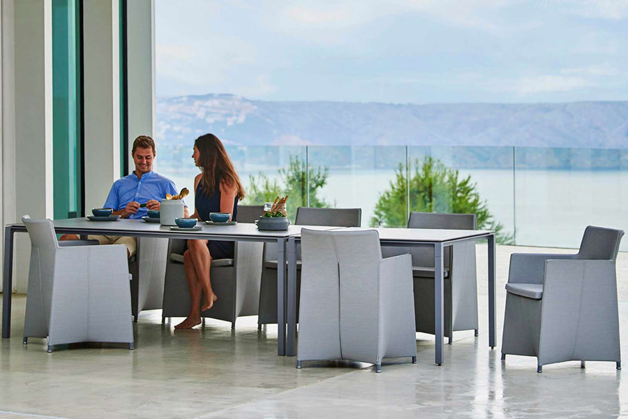 Pure Aluminum Square Dining Table by Cane-Line, showing pure aluminum square dining table with chairs in live shot.