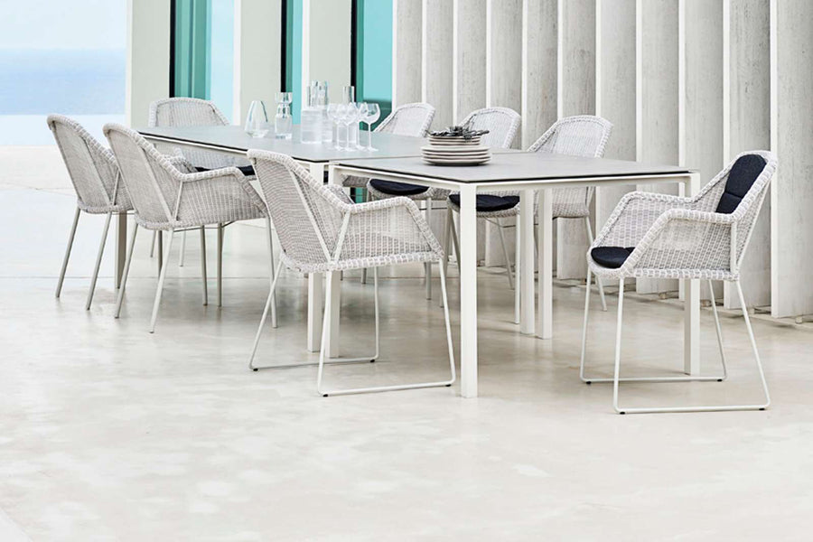 Pure Aluminum Square Dining Table by Cane-Line, showing pure aluminum square dining table with chairs in live shot.