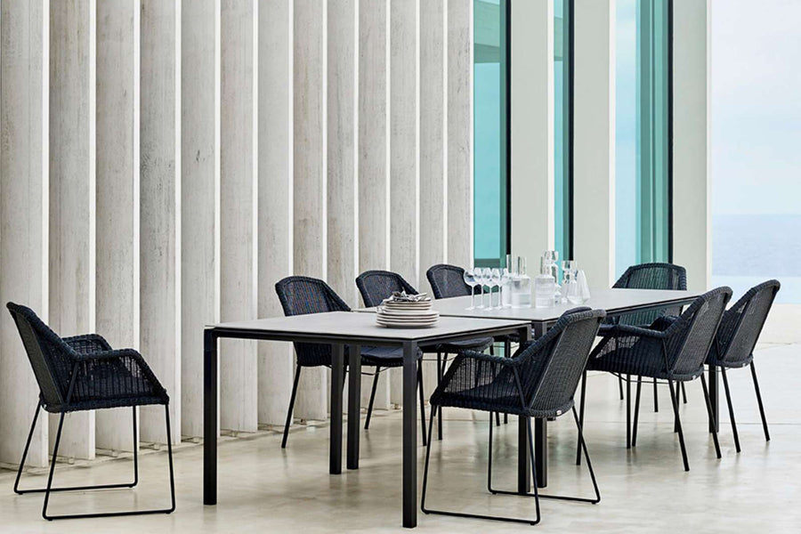 Pure Aluminum Square Dining Table by Cane-Line, showing pure aluminum square dining table with chairs in live shot.