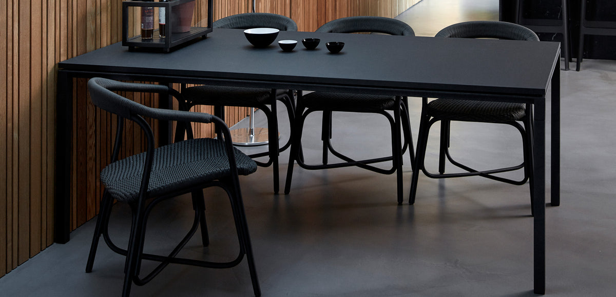 Pure Indoor Aluminum Rectangular Dining Table by Cane-Line, showing pure indoor aluminum rectangular dining table with chairs in live shot.
