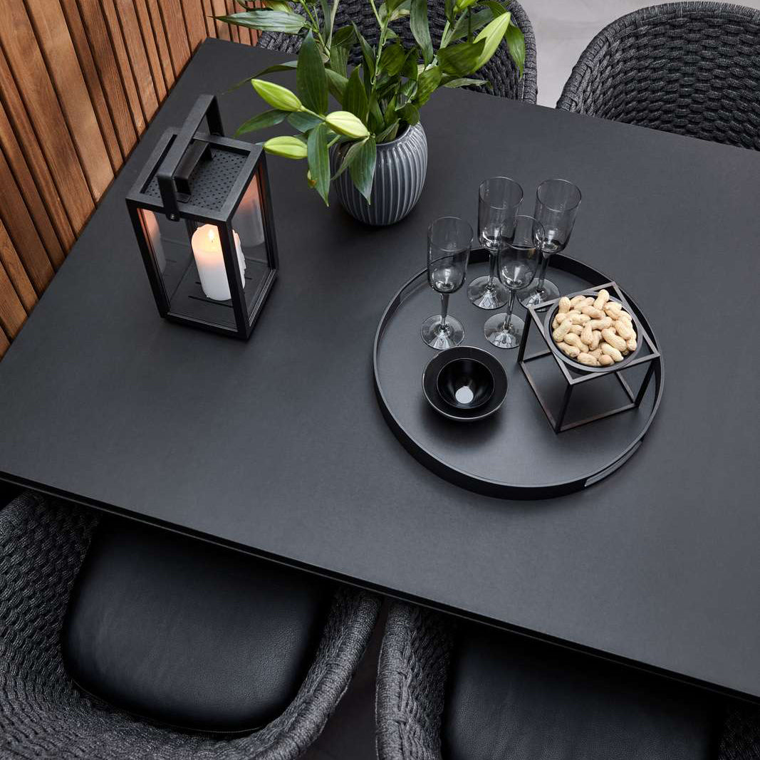 Pure Indoor Aluminum Rectangular Dining Table by Cane-Line, showing top view of pure indoor aluminum rectangular dining table with chairs in live shot.