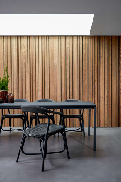 Pure Indoor Aluminum Rectangular Dining Table by Cane-Line, showing pure indoor aluminum rectangular dining table with chairs in live shot.
