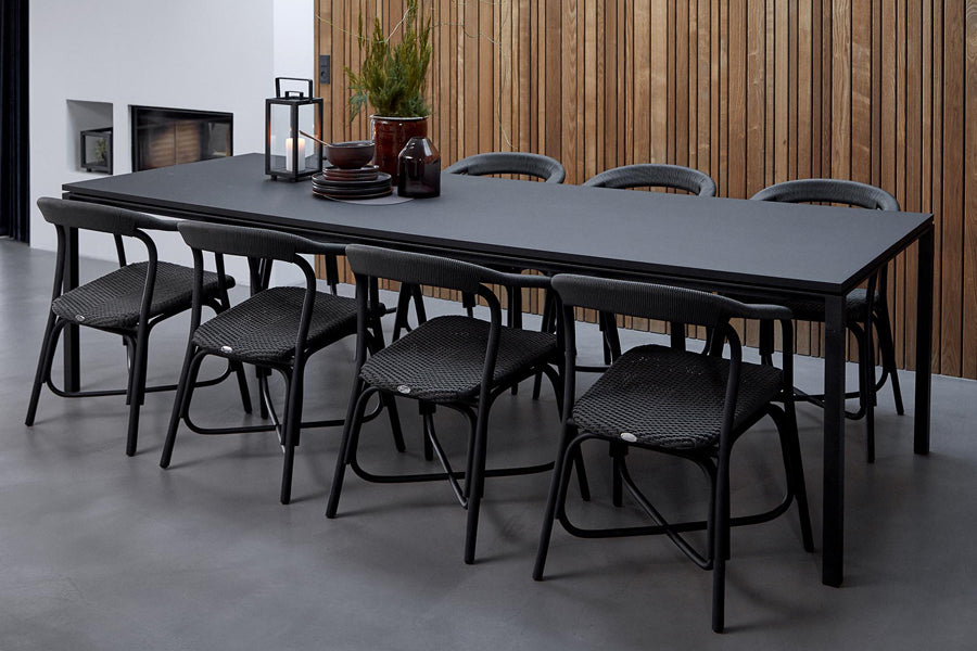 Pure Indoor Aluminum Rectangular Dining Table by Cane-Line, showing pure indoor aluminum rectangular dining table with chairs in live shot.