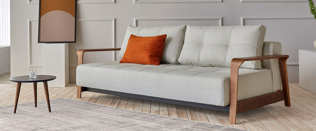 Ran D.E.L Sofa Bed by Innovation, showing ran d.e.l sofa bed with table in live shot.