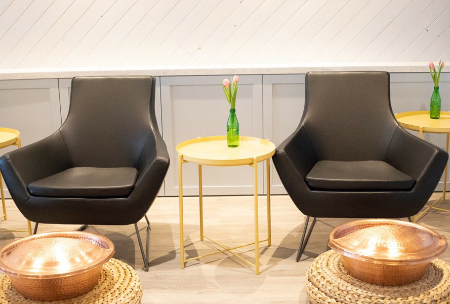 Rebecca Wire Sled Arm Chair by SohoConcept, showing front view of two wire sled arm chair with table in live shot.