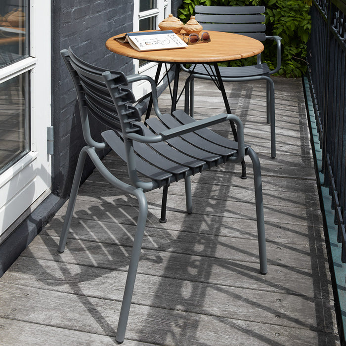 Reclips Outdoor Dining Chair by Houe, showing reclips outdoor dining chairs with table in live shot.