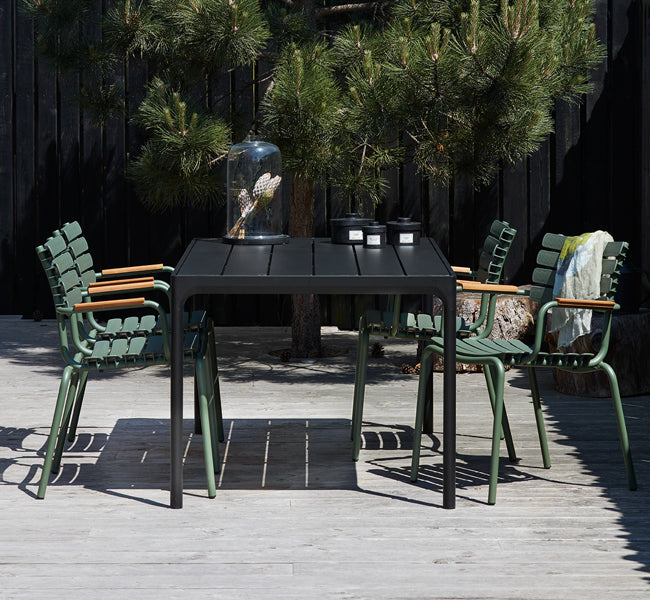 Reclips Outdoor Dining Chair by Houe, showing reclips outdoor dining chairs with table in live shot.