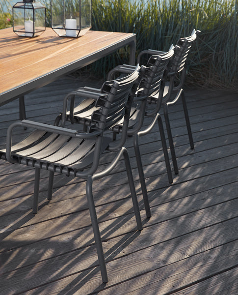 Reclips Outdoor Dining Chair by Houe, showing reclips outdoor dining chairs with table in live shot.