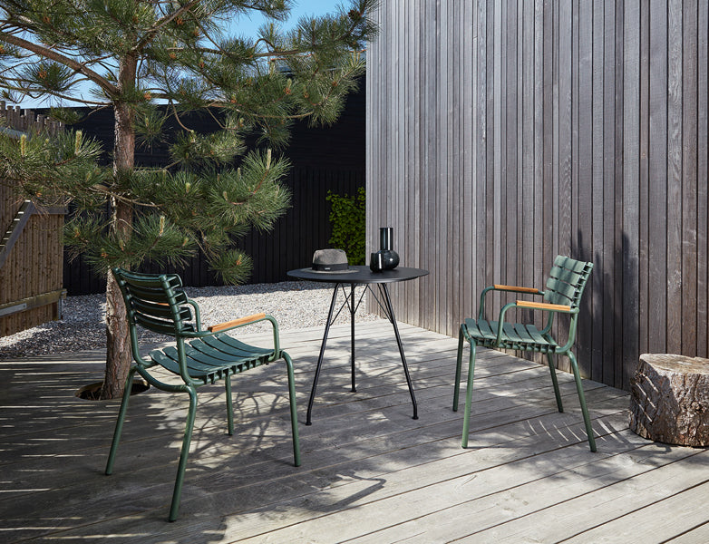 Reclips Outdoor Dining Chair by Houe, showing reclips outdoor dining chairs with table in live shot.
