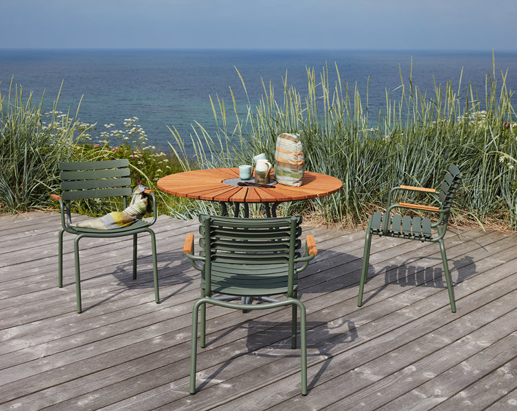 Reclips Outdoor Dining Chair by Houe, showing reclips outdoor dining chairs with table in live shot.