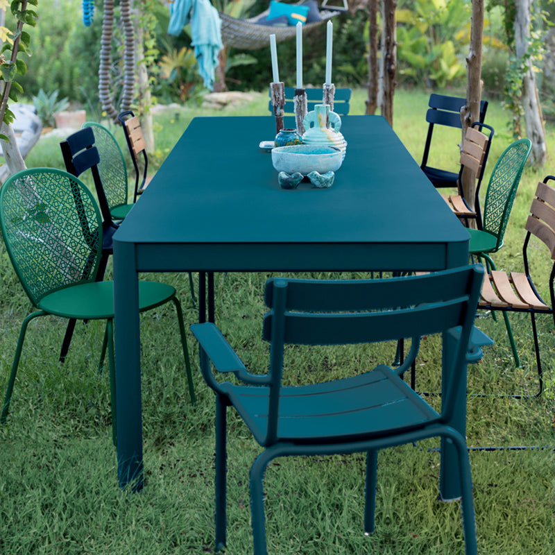Ribambelle Extension Tables by Fermob, showing ribambelle extension tables with chairs in live shot.