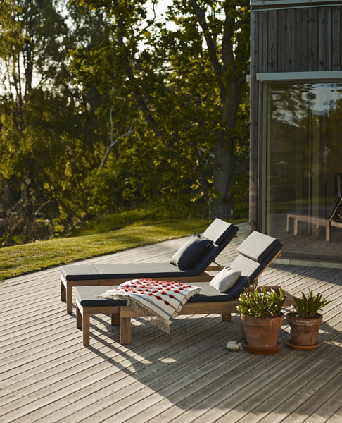 Riviera Sunlounger by Skagerak, showing two riviera sunloungers with cushions in live shot.