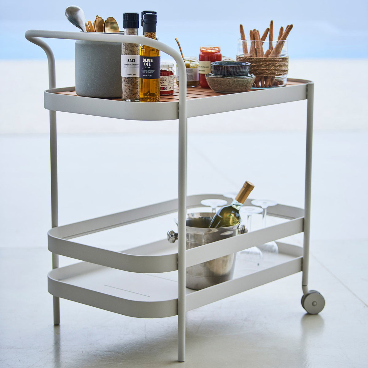 Roll Bar Trolley by Cane-Line, showing roll bar trolley in live shot.