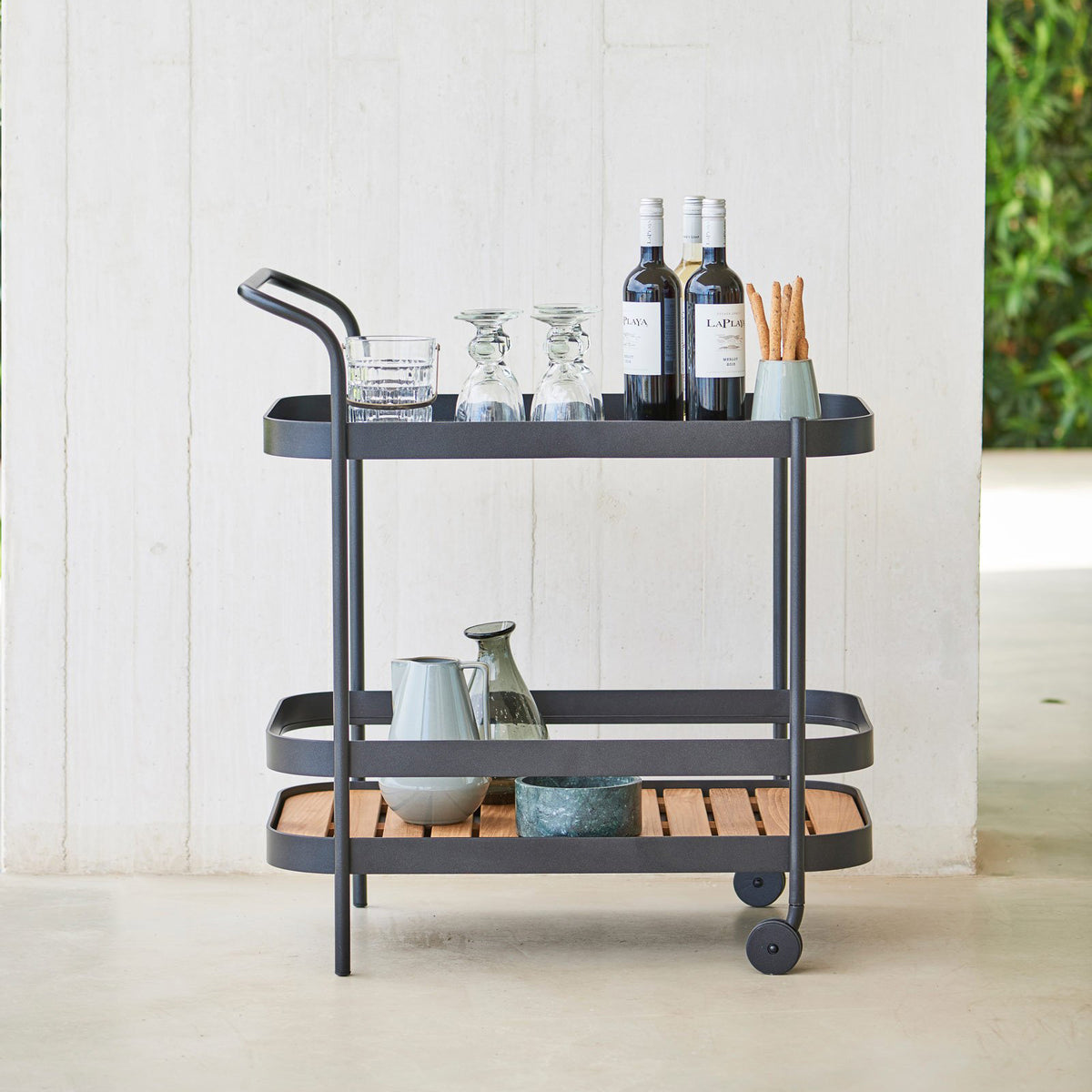 Roll Bar Trolley by Cane-Line, showing roll bar trolley in live shot.