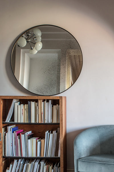 Aged Wall Mirror by Ethnicraft, showing front view of bronze wall mirror in live shot.