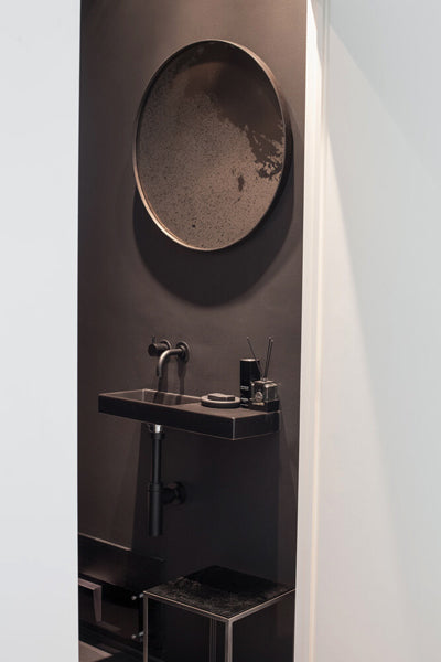 Aged Wall Mirror by Ethnicraft, showing front view of bronze wall mirror in live shot.