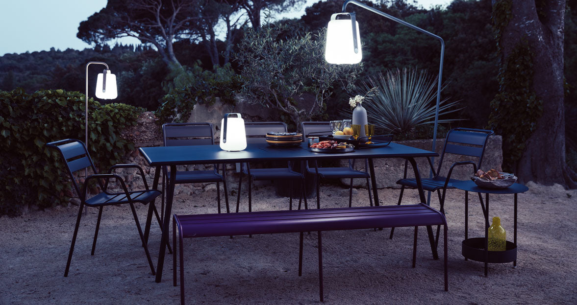 Salsa Side Table by Fermob, showing of side table with chairs & bench in the live shot.