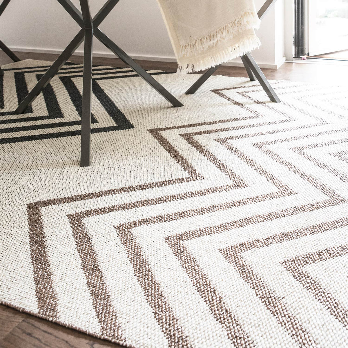 Sapmi Woven Plastic Rug by Brita, showing closeup view of sapmi woven plastic rug in live shot.