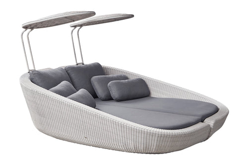 Savannah Daybed Left Module by Cane-Line, showing angle view of savannah daybed left module with right module in white grey fiber weave/grey natte cushion set.