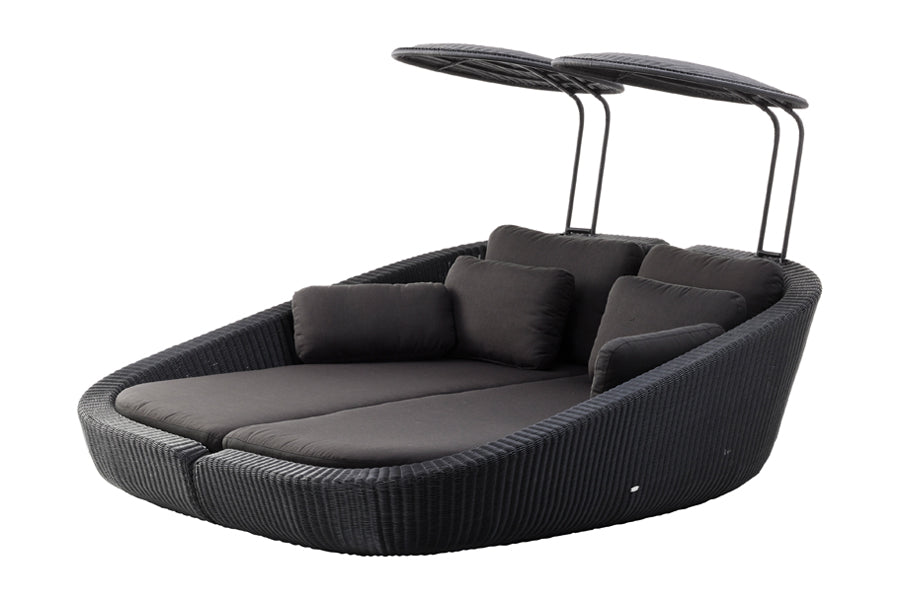 Savannah Daybed Left Module by Cane-Line, showing angle view of savannah daybed left module with right module in black fiber weave/grey natte cushion set.