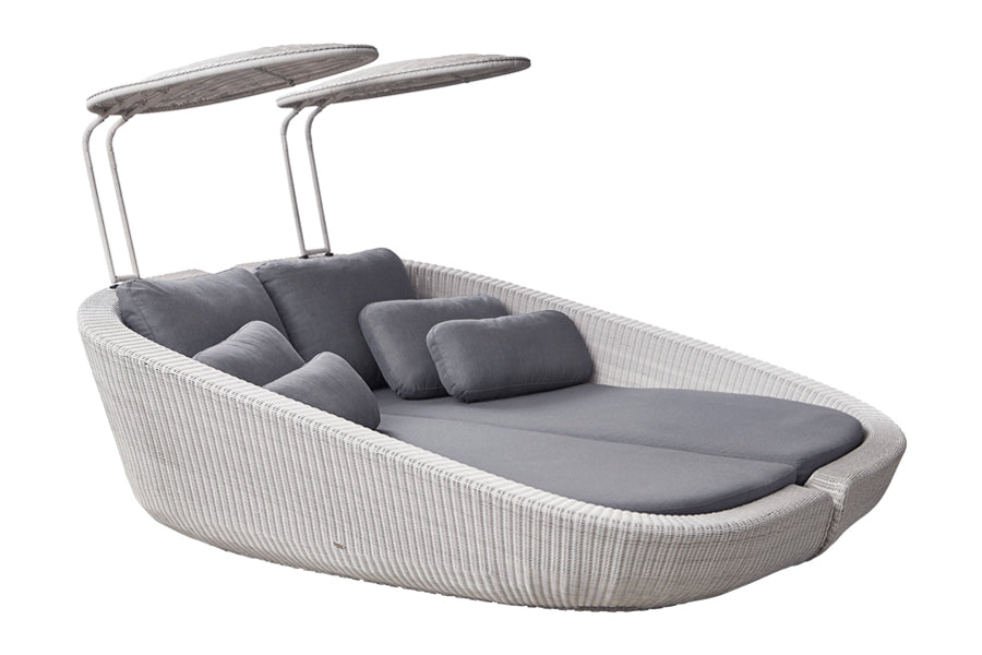 Savannah Daybed Right Module by Cane-Line, showing angle view of savannah daybed right module with left module in white grey fiber weave/grey natte cushion set.